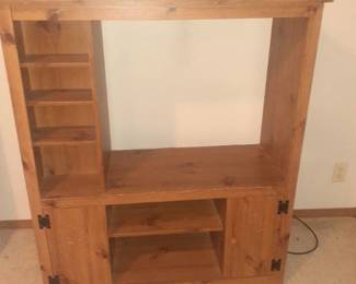 Wooden entertainment center. 47 x 42 x 17. Left side has a place for CDs and or DVDs. Located in basement. Bring Help