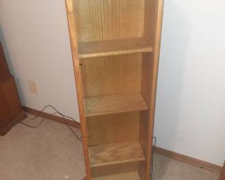 DVD or CD holder. Swivels and has glass doors. 44 x 12 x 13. Located in basement