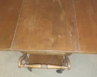 Wooden, rolling serving cart. Top has damage. With sides up 29 x 41 x 32. Handle comes down too. With sides down 29 x 19 x 32. Located in basement