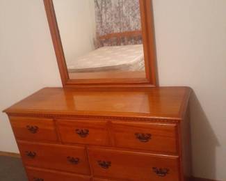 Dresser with 6 drawers and attached mirror. 65 x 47 x 18. Top has some water damage. Bring Help it's located in basement