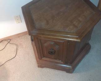 Octagon shaped end table. Bottom has storage. 20 x 15 x 24. It's located in basement