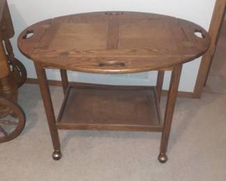 Rolling serving cart. Top comes completely off. With sides down 27 x 35 x 25. Located in basement