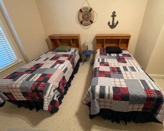 twin size beds with bookshelf headboards; bedding