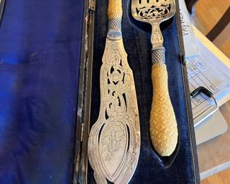 $450. Attributed to Mappin & Webb heavy plated with celluloid handles fish set in case.