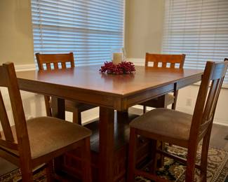 Oak counter height dining room table….does have extending leaf….there are only 4 chairs in the picture…but I do have 6 total…area rug is also available. 