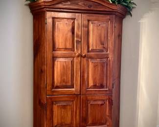 Corner TV armoire. Bottom half has shelves for storage..the tv opening is 26” wide by 25 “ tall