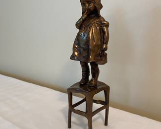 Bronze baby girl on chair sculpture