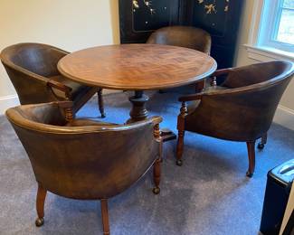 Adjustable round table with four tub chairs on casters