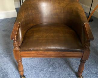 Adjustable round table with four tub chairs on casters