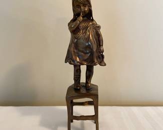 Bronze baby girl on chair sculpture