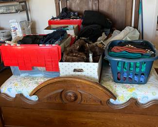 Antique bed holding misc fabric.