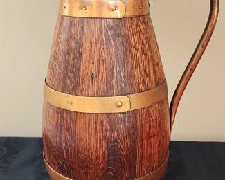 English wood stave pitcher with copper bands, handle, and spout.
