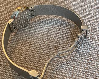 8- Dior - Christian Dior - Model D Dior, large model 25mm, stainless steel bracelet, and bezel pink gold and diamond, red lacquer face. $3,600