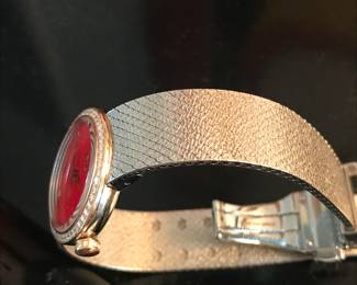8- Dior - Christian Dior - Model D Dior, large model 25mm, stainless steel bracelet, and bezel pink gold and diamond, red lacquer face. $3,600