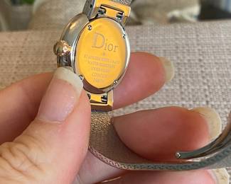 8- Dior - Christian Dior - Model D Dior, large model 25mm, stainless steel bracelet, and bezel pink gold and diamond, red lacquer face. $3,600