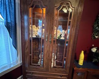 Tall lighted curio cabinet