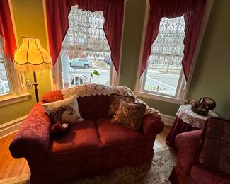 Victorian style living room love seat, sofa, end table and coffee table. Persian rug. Stand up dual lights Victorian lamp.