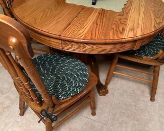 Solid oak lions claw table, two leafs and four chairs. Table without leaves is 48" and 71"with both in