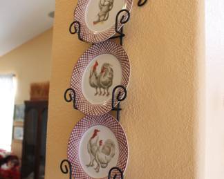 Rooster plates in holder on the wall