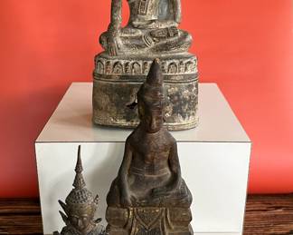 A collection of 18th century bronze and wood Thai Buddha figures