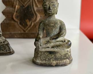 A collection of 18th century bronze and wood Thai Buddha figures