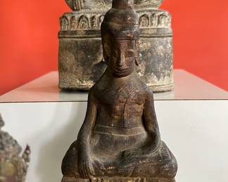 A collection of 18th century bronze and wood Thai Buddha figures