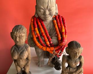 Carved wooden ancestor figures from Nagaland, India, along with a Naga glass bead and bronze necklace