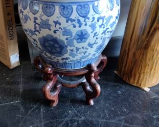 Large blue and white planner on teak stand.