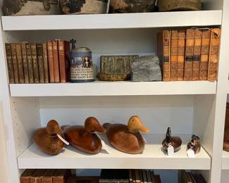 Duck Decoys, Antique Books, Mettlach Stein, Beaded Purses, Sudan Iron Ore Bookend, Safe Bank, and Post Office Box Bank.