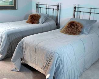 Pair Of Twin Bed Sets With Blue Linens And Mattress Toppers