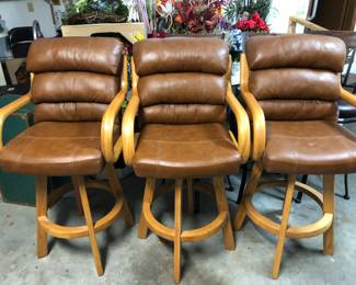 Three leather and oak bar stools
