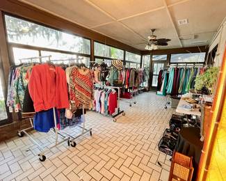 Sunroom Full of beautiful Ladies Clothing Handbags and shoes