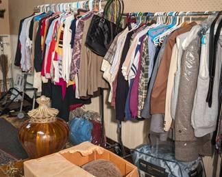 Woman's and Men's Clothing. Clothing Racks. Antique Lights. Comforter. 