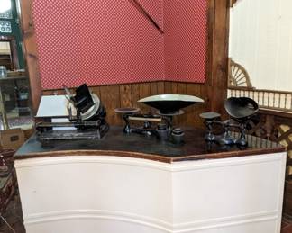 Display Counter with Storage. Antique Meat Slicer. Antique Balance Scales. Antique Push Vacuum.