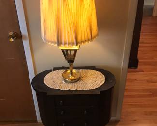 Old sewing table with brass lamp
