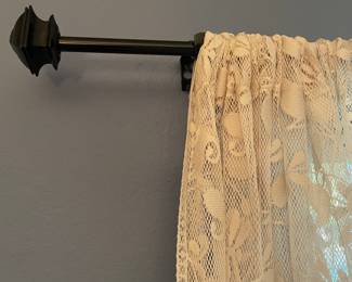 Several curtain rods and curtain panels