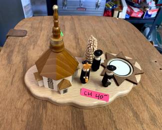 #137	wood Christmas display with candle and 3 priest and church	 $40.00 			
