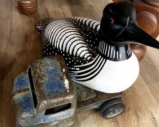 Hand carved duck hitchhiking on this antique truck.