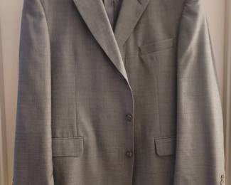 Lots of men's suits in different sizes.