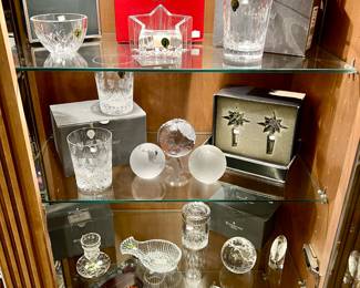 Two glass cabinets full of Waterford, Tiffany & Co.