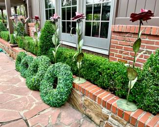 Lots of fun greenery-outdoor plastic green wreaths, metal flowers.