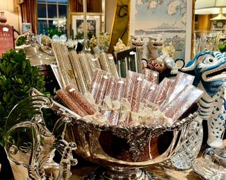 Large silver punch bowl full of sparkly candles.