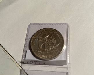 The reverse of the 1877 S Trade Dollar. This coin has a MICRO 's' mint mark. It appears that the employee used (maybe) the 's' that was designated for the quarterand NOT the Trade Dollar!!!