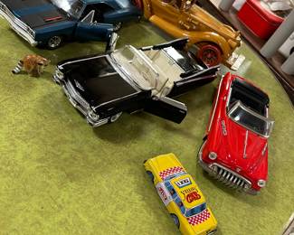 Buick Voilture sedan friction car, 
1959 Cadillac Eldorado (Maisto), 
1960s Yellow Taxi Cab (Japan), 
1969 Plymouth Road Runner-American Muscle (Ertl), handcrafted wood car.
