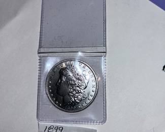 1899 - P Morgan Silver Dollar. An extremely tough date to find in any condition with only 300,000 coins minted at the Philadelphia mint!!! This is an EXCELLENT specimen.