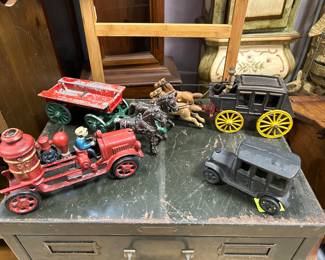 Stanley cast iron horse drawn hayrack wagon (upper left corner), horse drawn stage coach (upper right hand corner), and fire pumper with driver & cast-iron black vehicle (repo)