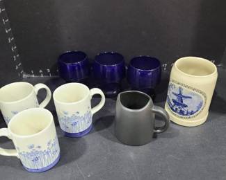 Various coffee mugs and 3 blue glasses (1 has a chip)