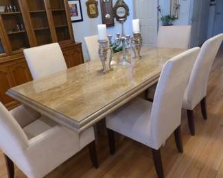 Travertine dining table with 6 neutral fabric chairs