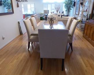 Travertine dining table with 6 neutral fabric chairs