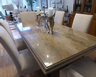 Travertine dining table with 6 neutral fabric chairs